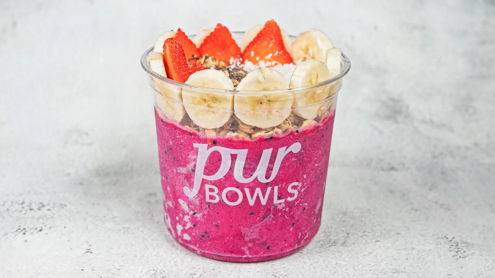 Pink Dragon Bowl with pitaya, banana, strawberries, coconut, and chia seeds