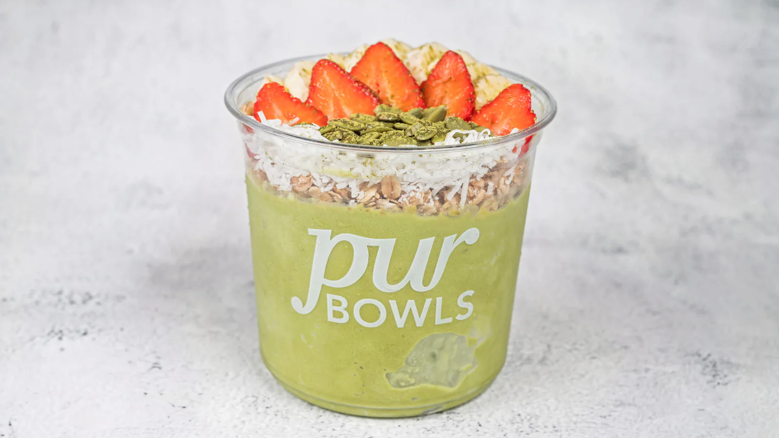 Green Goodness Bowl with matcha, banana, strawberries, coconut, and pumpkin seeds